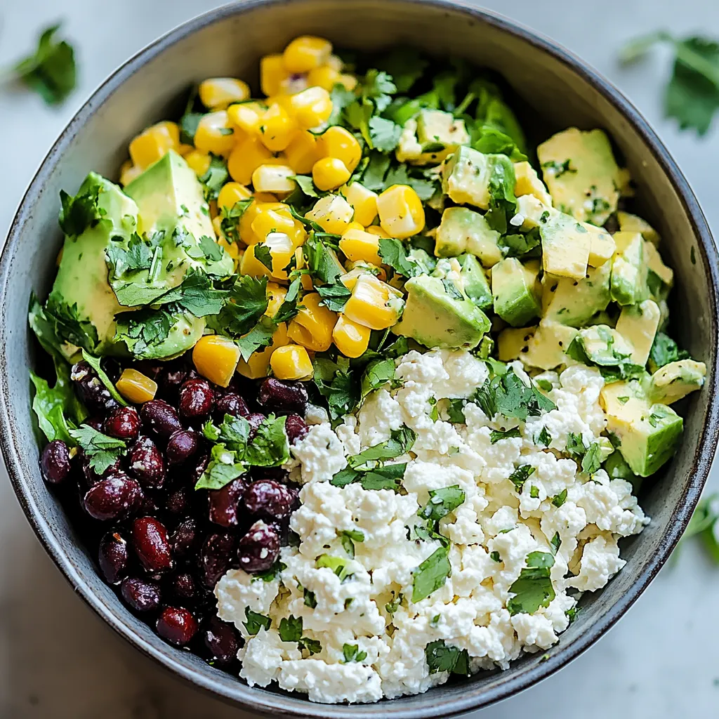 A bowl of food with avocado, corn, beans, and cheese.