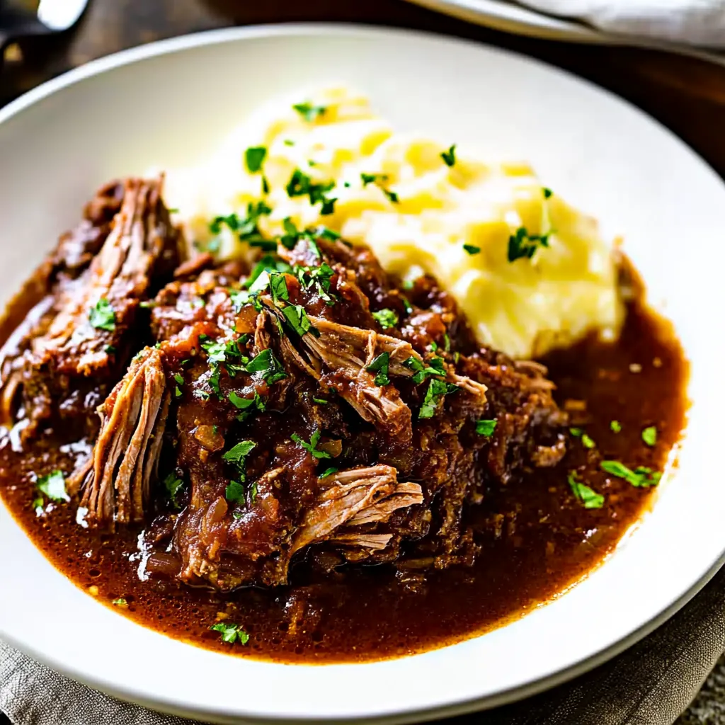 A plate of meat and potatoes.