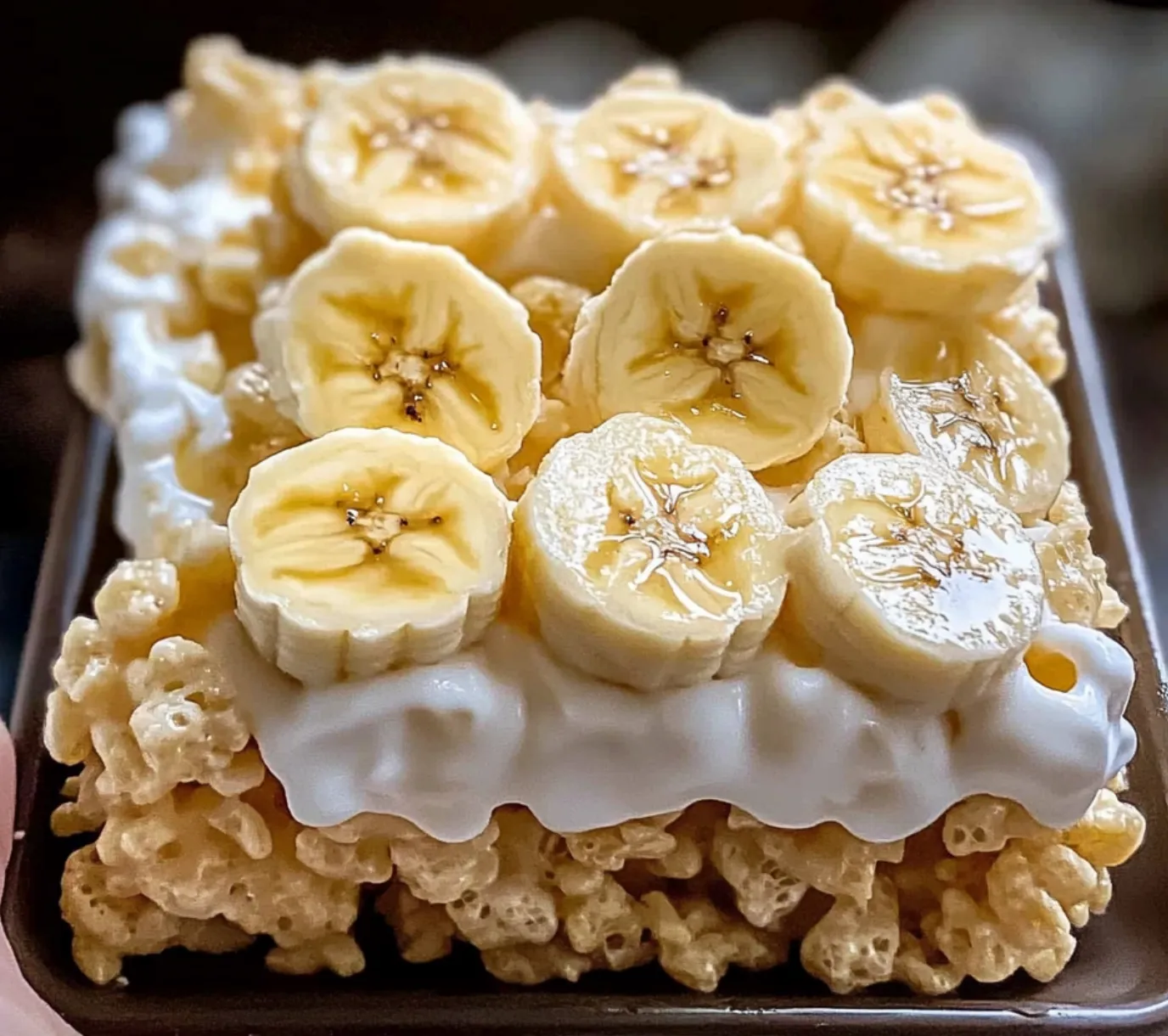 A bowl of cereal with bananas and marshmallows.