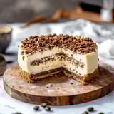 A slice of cake on a wooden table.