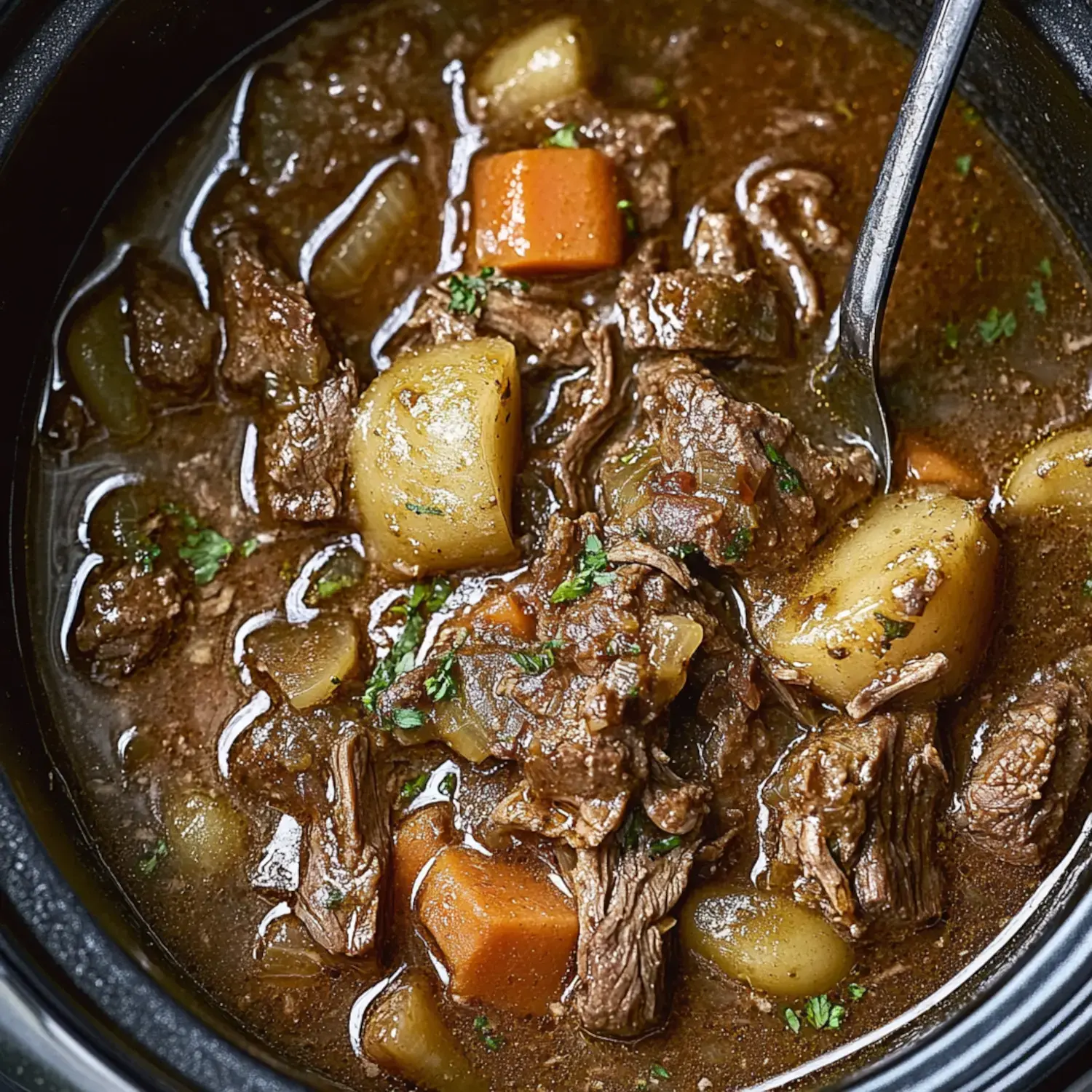 A bowl of hearty beef stew featuring tender chunks of beef, potatoes, carrots, and green vegetables in a rich broth.