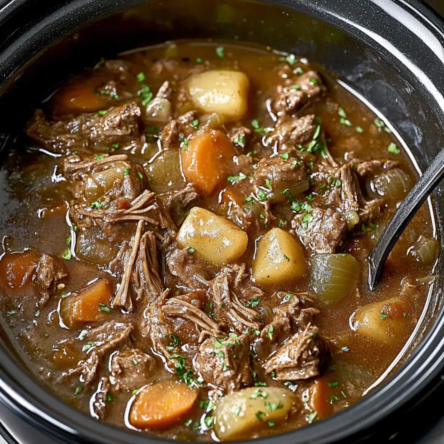 A close-up of a hearty beef stew with shredded meat, potatoes, carrots, and herbs in a dark broth, served in a black bowl with a spoon.