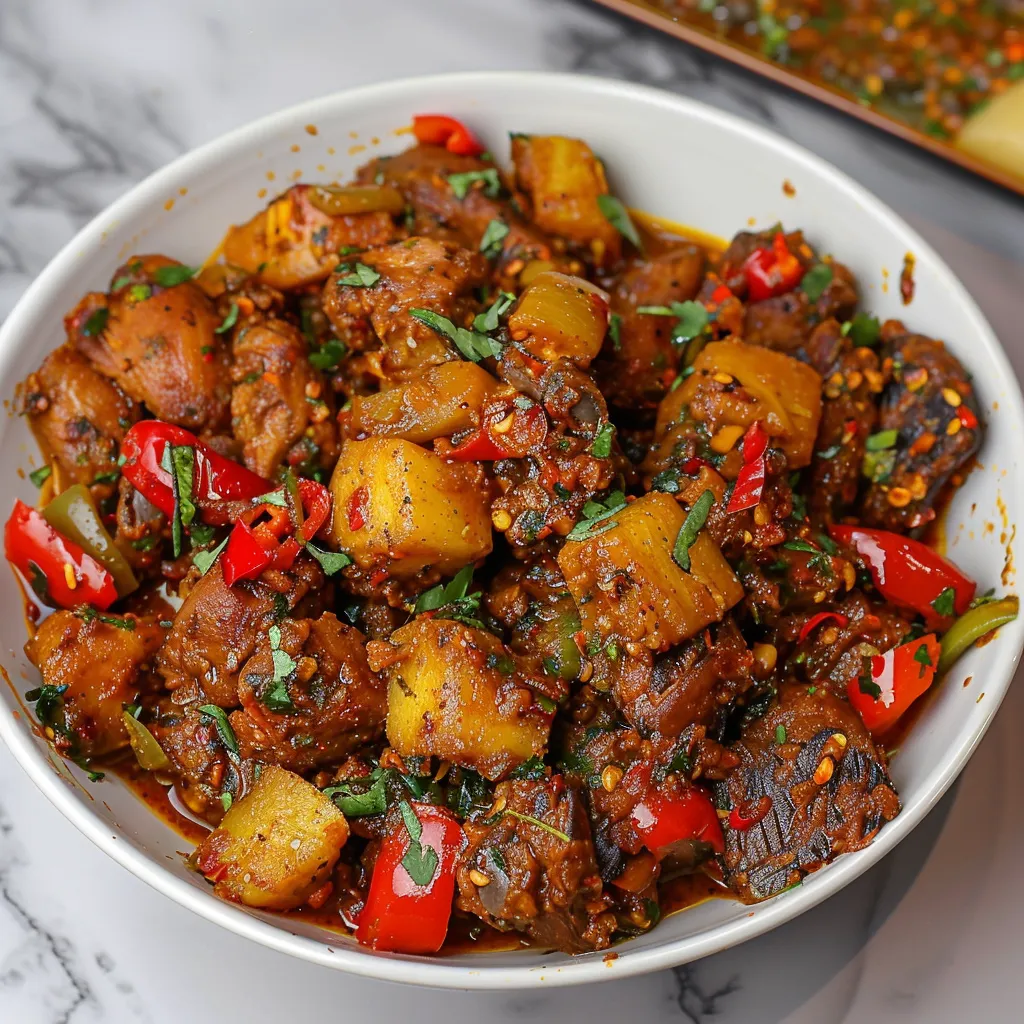 Spicy Gizdodo with tender gizzards and caramelized plantains in a rich pepper sauce.