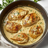 Tender chicken cooked in a creamy garlic sauce for a rich and comforting meal.