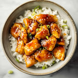 Crispy baked orange chicken coated in a sweet and tangy orange glaze.