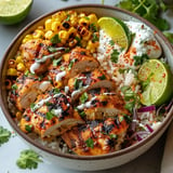 Flavorful street corn chicken rice bowl with creamy corn, juicy chicken, and zesty seasoning.