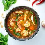 Spicy and tangy Tom Yum soup with shrimp, lemongrass, and rich Thai flavors.