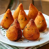 Crispy Brazilian coxinhas filled with seasoned shredded chicken and creamy dough.