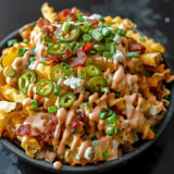 Crispy fries loaded with melted cheese, crispy bacon, and savory toppings.